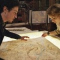 George (BEN FELDMAN) and Scarlett (PERDITA WEEKS) map their quest through miles of twisting catacombs beneath the streets of Paris in As Above/So Below.