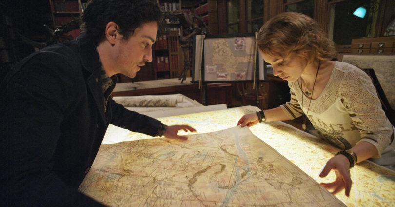 George (BEN FELDMAN) and Scarlett (PERDITA WEEKS) map their quest through miles of twisting catacombs beneath the streets of Paris in As Above/So Below.