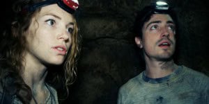 Scarlett (PERDITA WEEKS) and George (BEN FELDMAN) traverse miles of twisting catacombs beneath the streets of Paris in As Above/So Below.