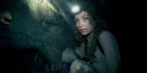 Scarlett (PERDITA WEEKS) traverses miles of twisting catacombs beneath the streets of Paris in As Above/So Below.